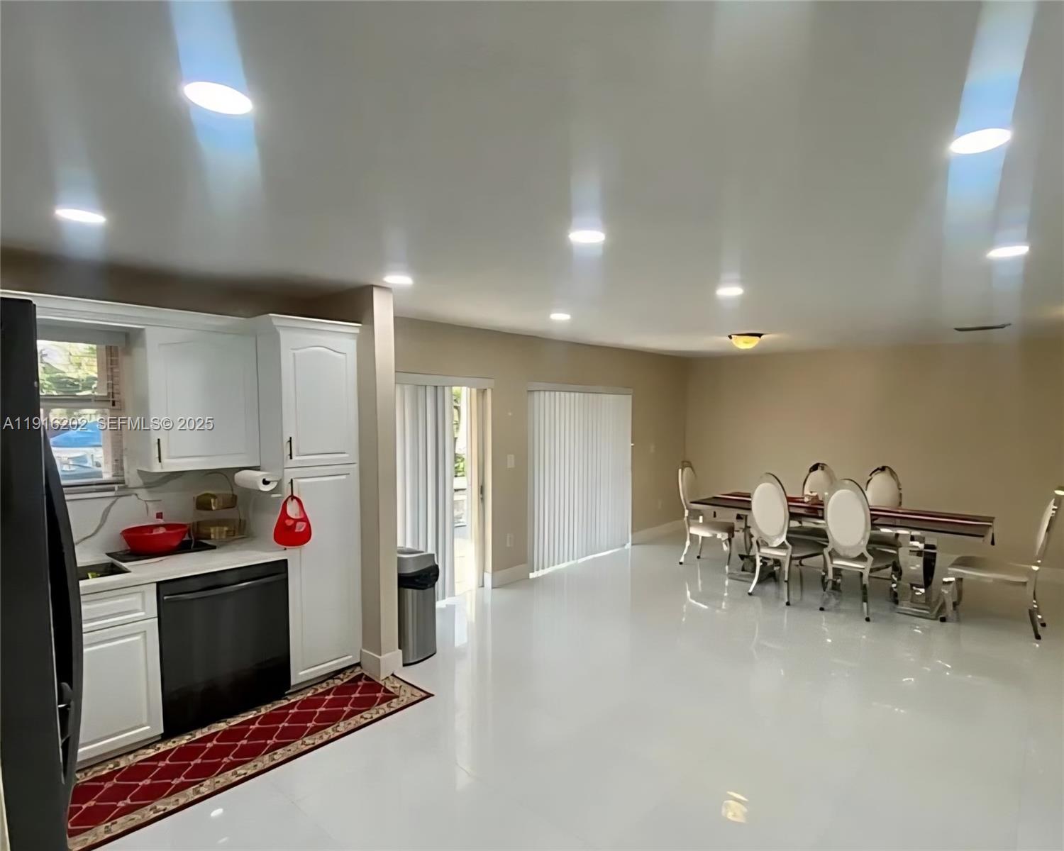 8568 Southwest 211th Terrace, Unit 8576 Cutler Bay, FL 33189 - Photo 4 of 12 a kitchen with stainless steel appliances kitchen island granite countertop a sink and cabinets