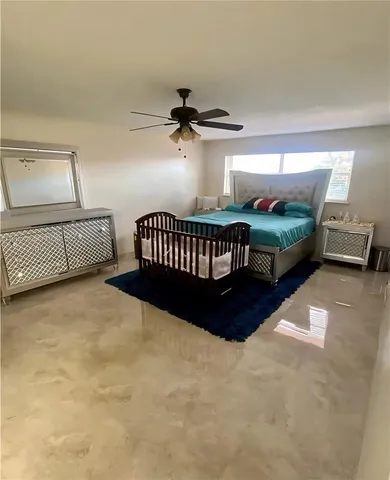 a bedroom with bed and window