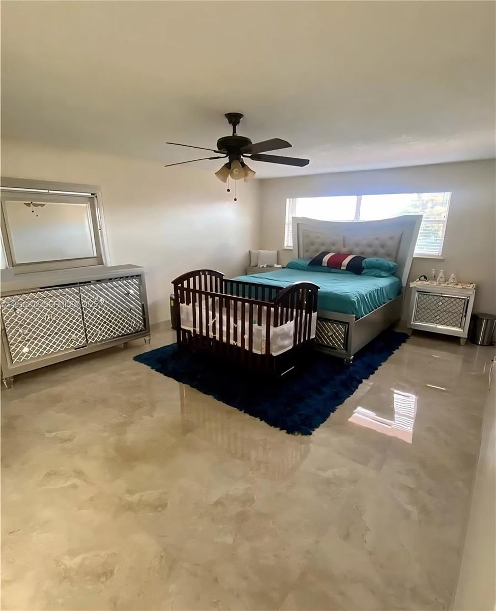 8568 Southwest 211th Terrace, Unit 8576 Cutler Bay, FL 33189 - Photo 6 of 12 a bedroom with bed and window