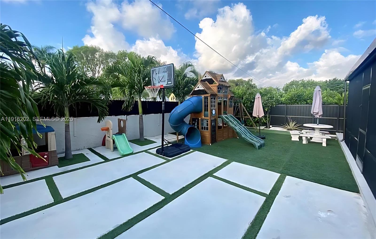 8568 Southwest 211th Terrace, Unit 8576 Cutler Bay, FL 33189 - Photo 10 of 12 a view of a park with swings