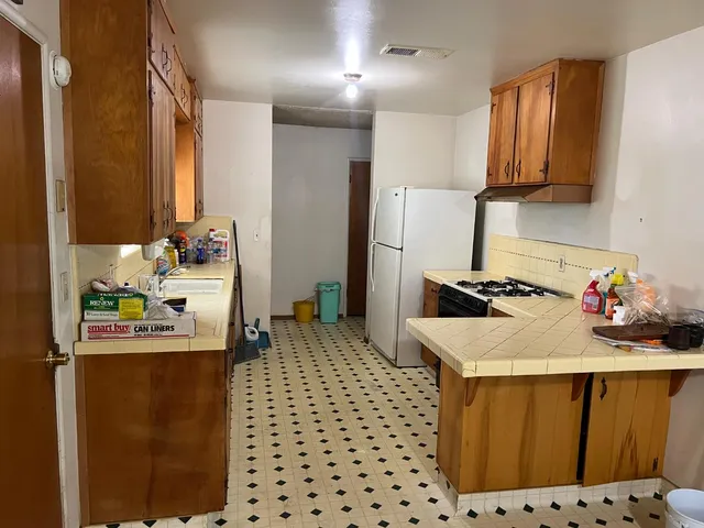 a kitchen with a sink appliances and cabinets