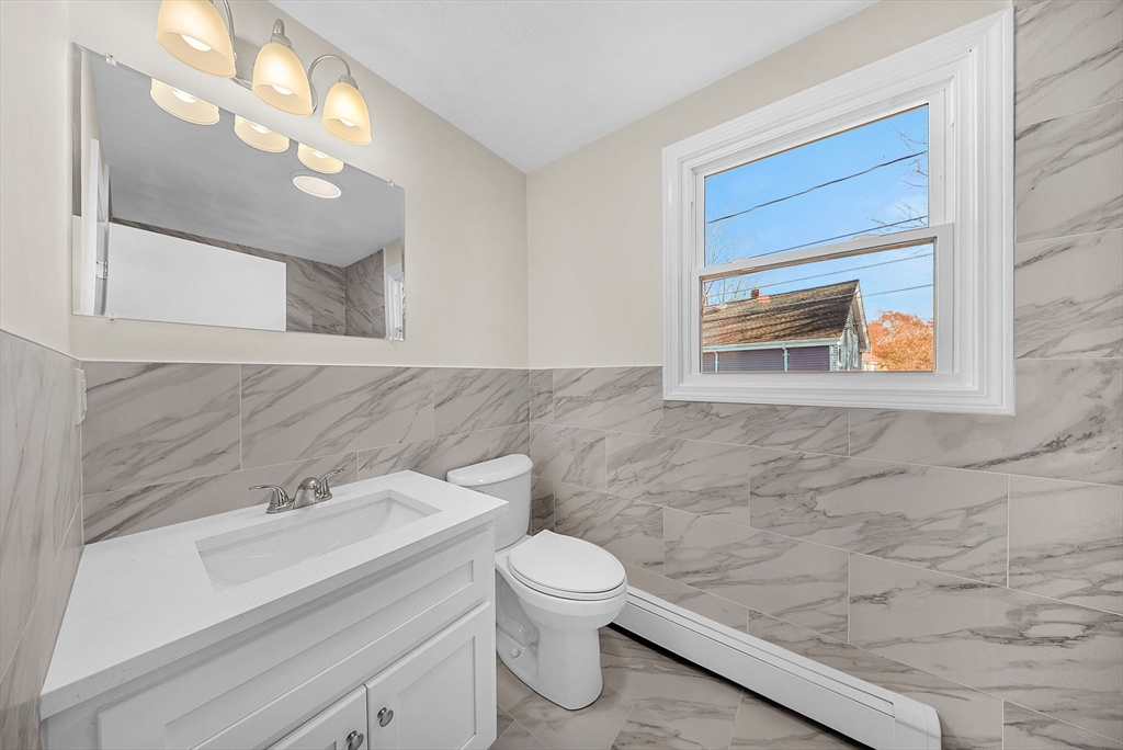 2 Cocci Way, Unit 2 Dedham, MA 02026 - Photo 23 of 30 a bathroom with a toilet a sink and mirror