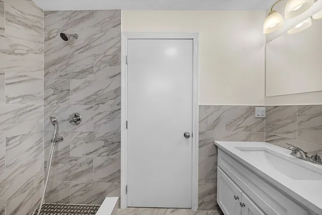 a bathroom with a sink toilet and shower