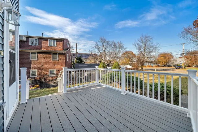 a view of a house with a wooden deck