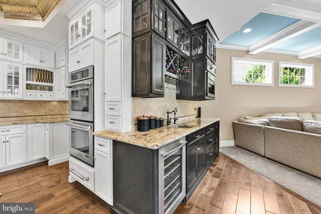 a spacious bedroom with a large bed and a chandelier