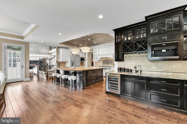 a bathroom with a granite countertop bathtub sink double vanity and a shower