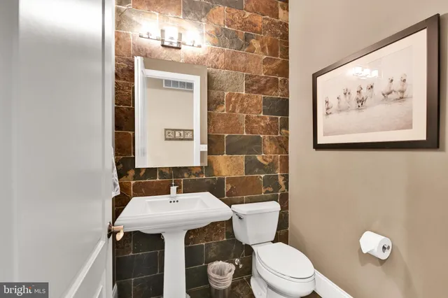 a dining room with furniture a floor to ceiling window and wooden floor