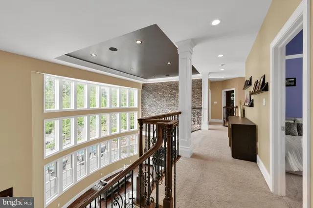 a front view of a house with a yard and green space