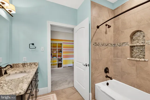 a view of a white house with a big yard plants and large tree