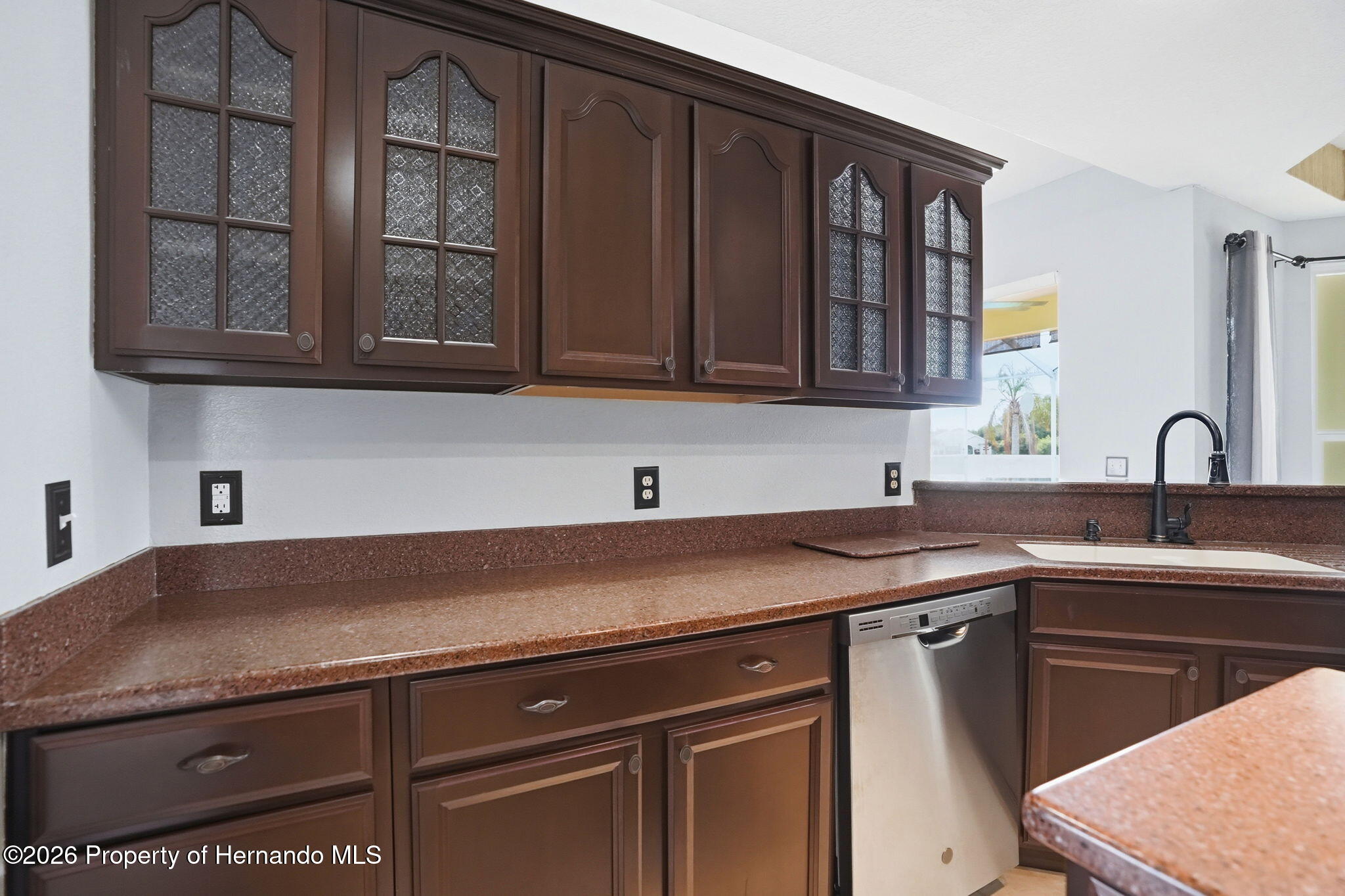 18131 Rivard Boulevard Brooksville, FL 34604 - Photo 17 of 66 a kitchen with granite countertop a sink and cabinets