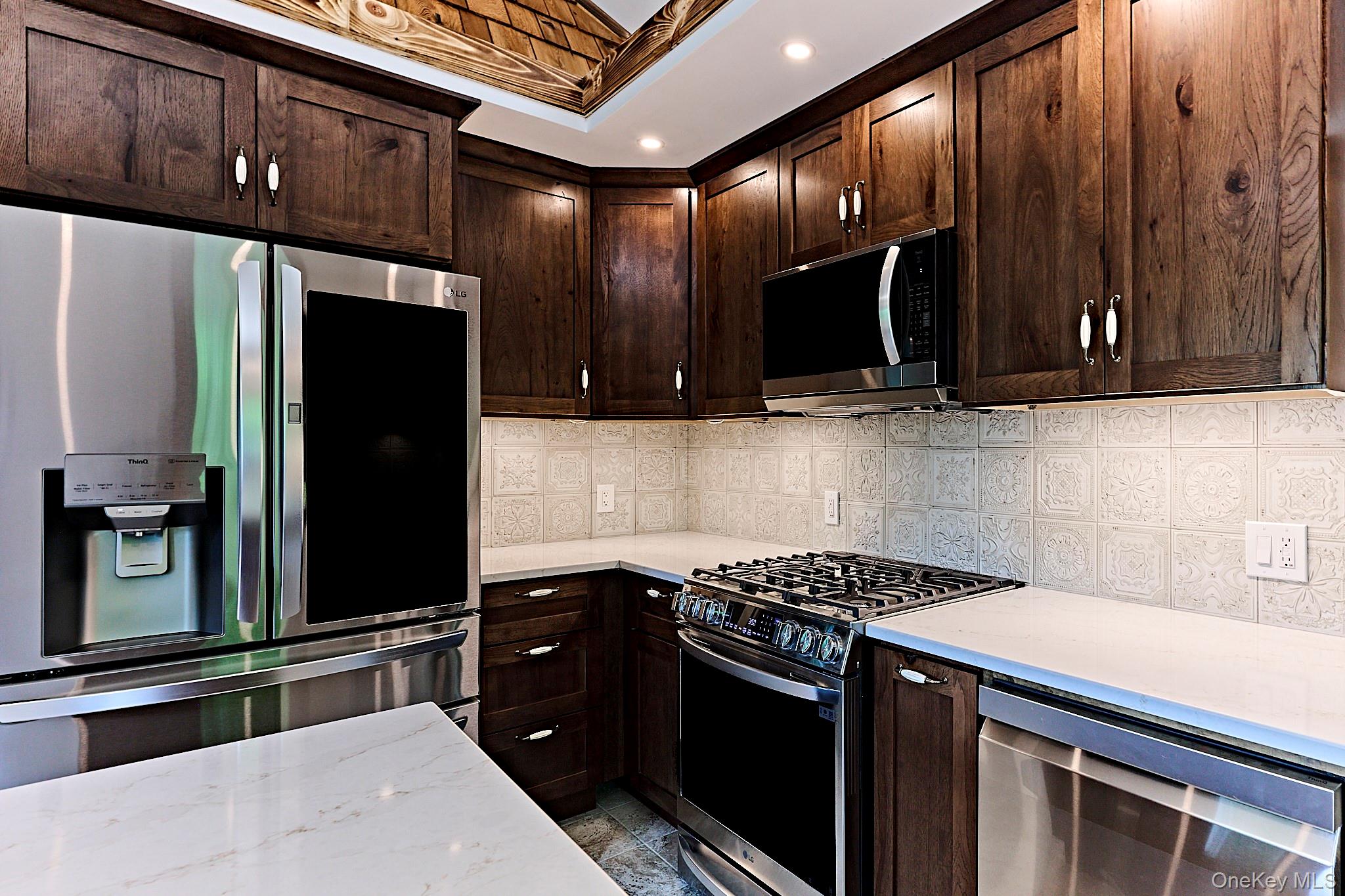 608 High Road Glen Spey, NY 12737 - Photo 12 of 37 a kitchen with stainless steel appliances granite countertop a refrigerator and a stove top oven