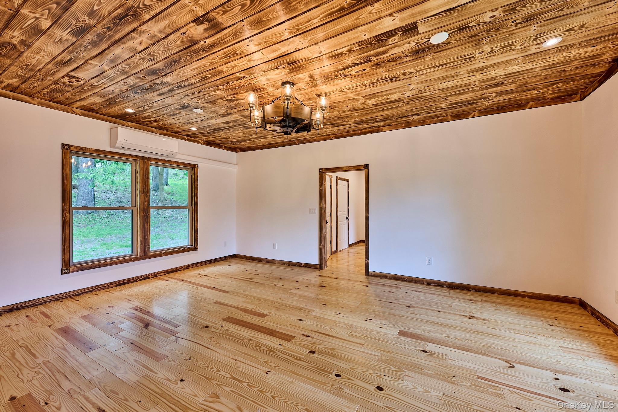 608 High Road Glen Spey, NY 12737 - Photo 18 of 37 a view of an empty room with wooden floor and a window