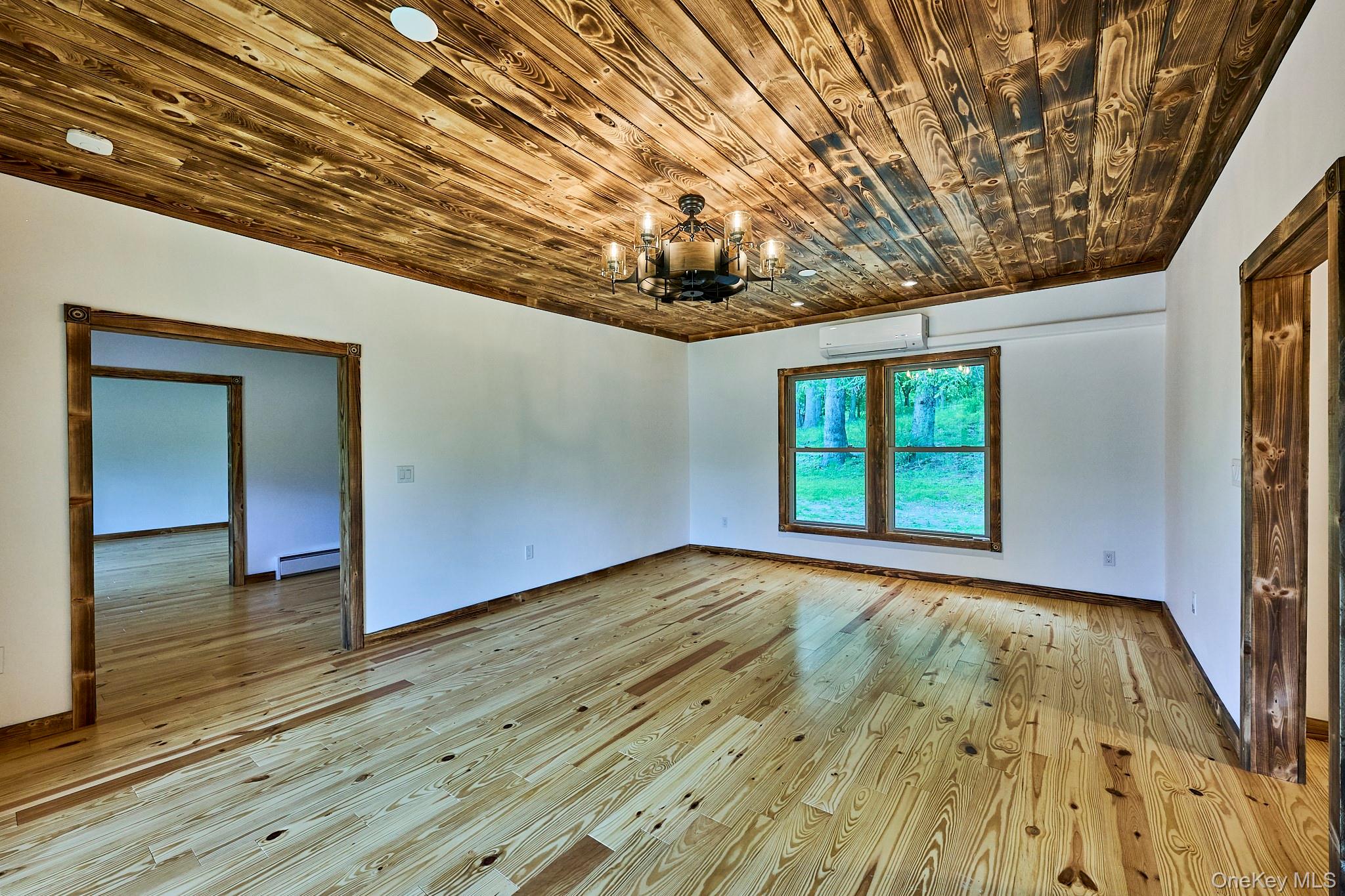 608 High Road Glen Spey, NY 12737 - Photo 19 of 37 a view of an empty room with wooden floor and a window