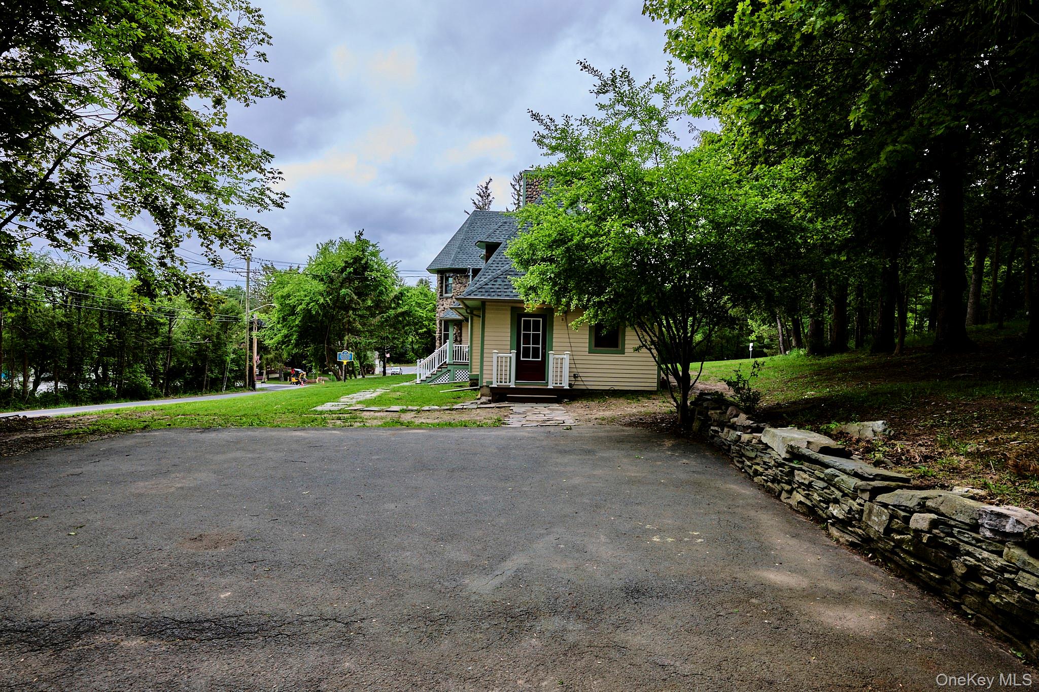 608 High Road Glen Spey, NY 12737 - Photo 9 of 37 a view of a house with large trees and a small yard