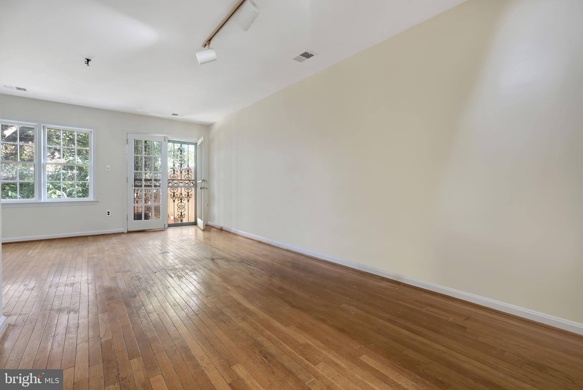1649 Park Road Northwest Washington, DC 20010 - Photo 4 of 33 wooden floor in an empty room with a window