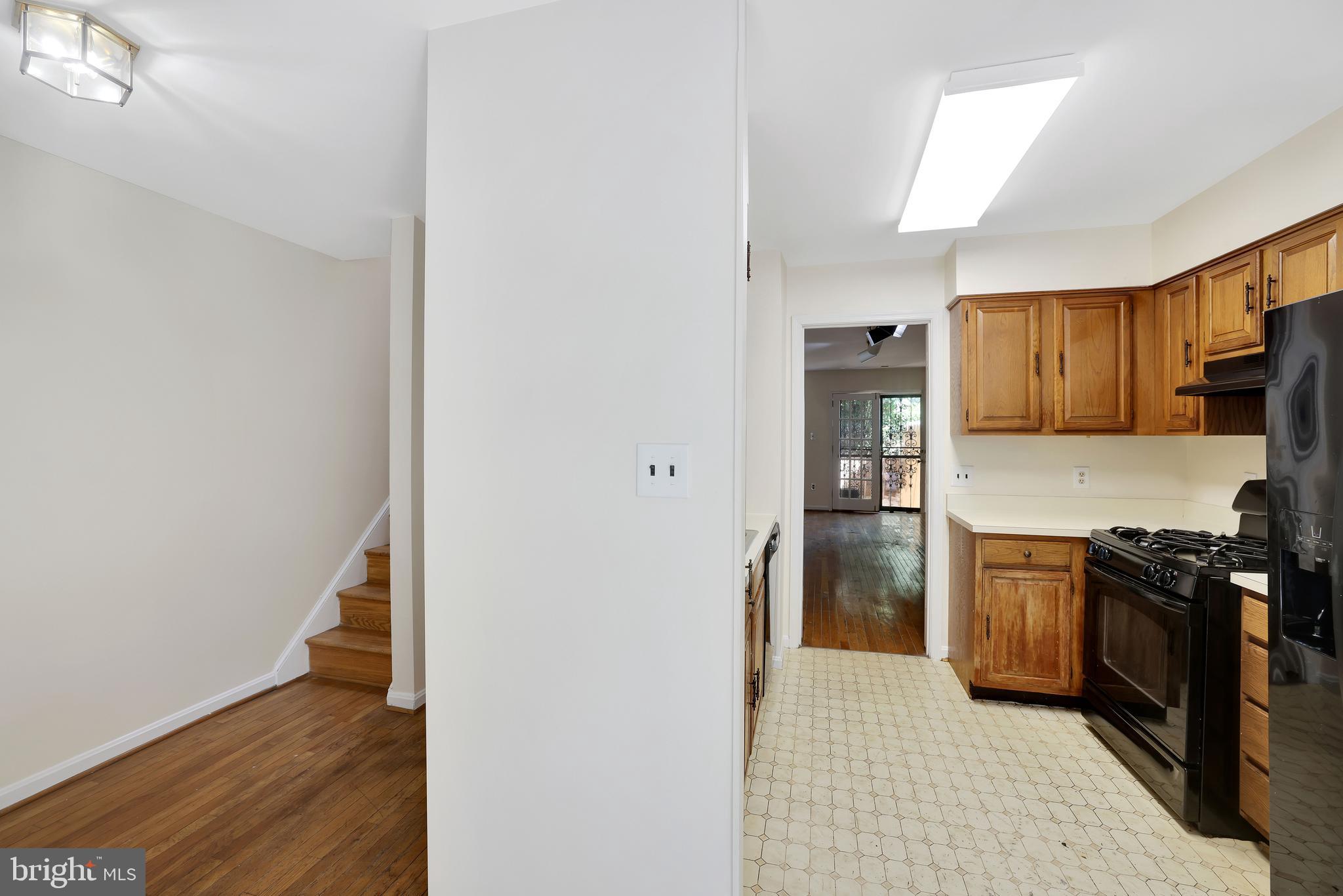 1649 Park Road Northwest Washington, DC 20010 - Photo 6 of 33 a kitchen with a refrigerator and a stove top oven