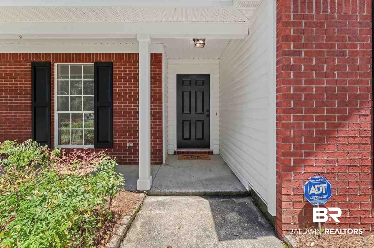 10251 Windmill Road Fairhope, AL 36532 - Photo 8 of 44 Doorway to property featuring brick siding