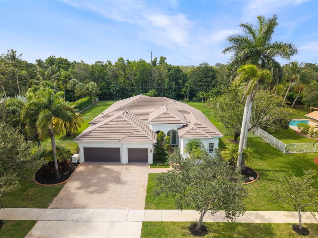 a aerial view of a house next to a yard