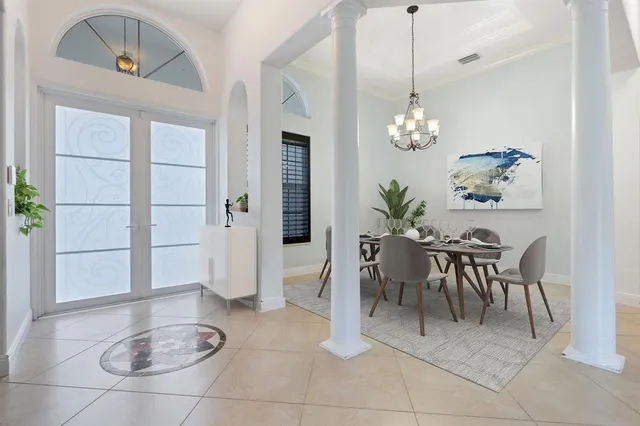 a dining room with furniture and a chandelier
