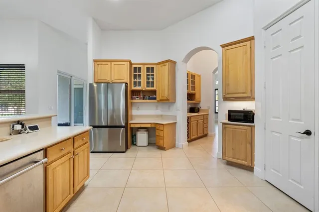 a kitchen with stainless steel appliances a refrigerator sink and cabinets