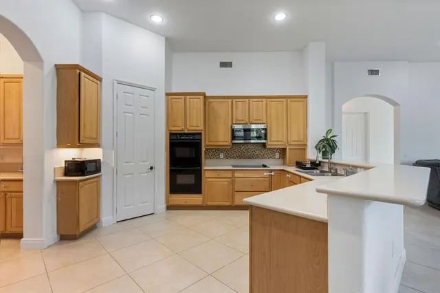 a kitchen with stainless steel appliances a refrigerator sink and stove