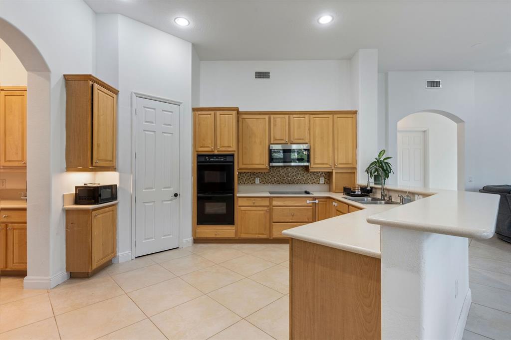 15651 Southwest 15th Street Davie, FL 33326 - Photo 17 of 47 a kitchen with stainless steel appliances a refrigerator sink and stove