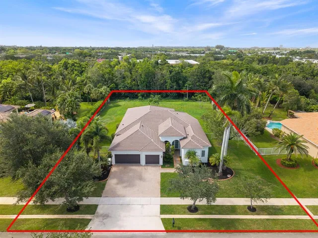 a aerial view of a house with a yard
