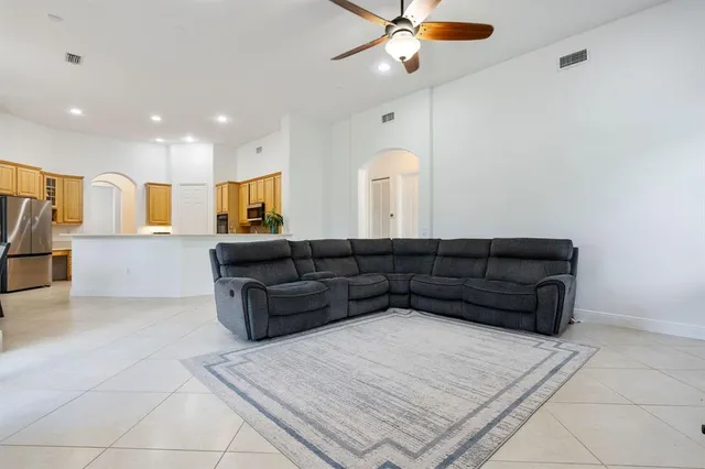 a living room with furniture and a chandelier