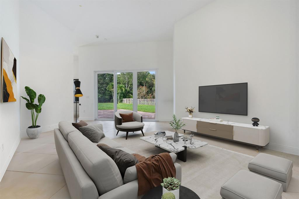 15651 Southwest 15th Street Davie, FL 33326 - Photo 25 of 47 a living room with furniture and a flat screen tv