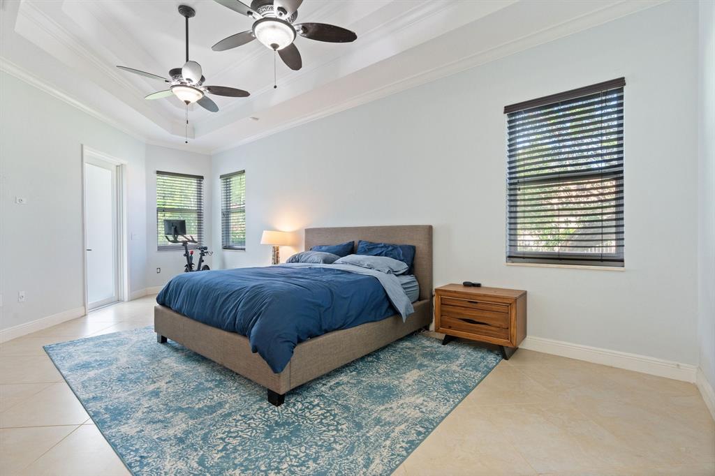 15651 Southwest 15th Street Davie, FL 33326 - Photo 27 of 47 a spacious bedroom with a bed and a chandelier