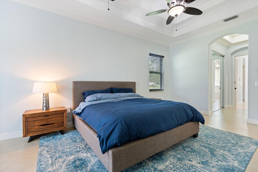 15651 Southwest 15th Street Davie, FL 33326 - Photo 28 of 47 a bedroom with a bed chandelier and dresser