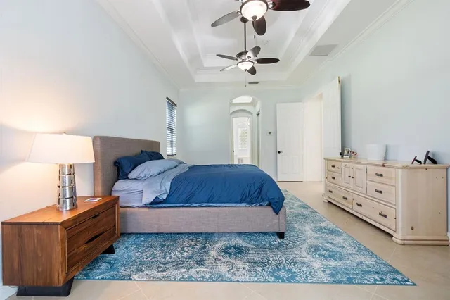 a spacious bedroom with a bed and cabinets