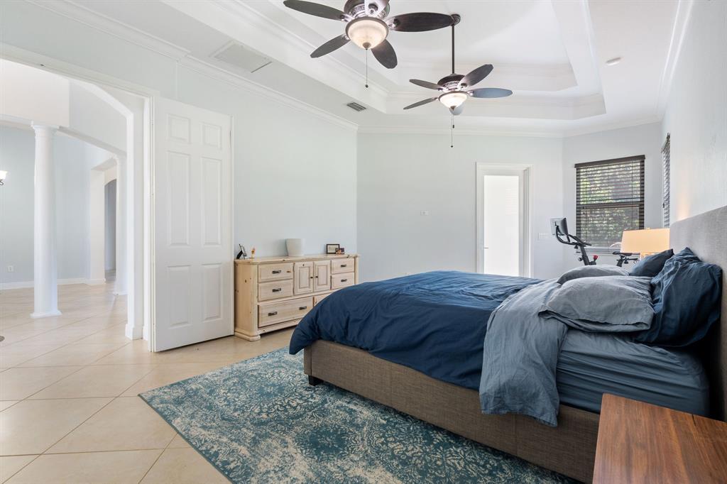 15651 Southwest 15th Street Davie, FL 33326 - Photo 30 of 47 a bedroom with a bed and a ceiling fan