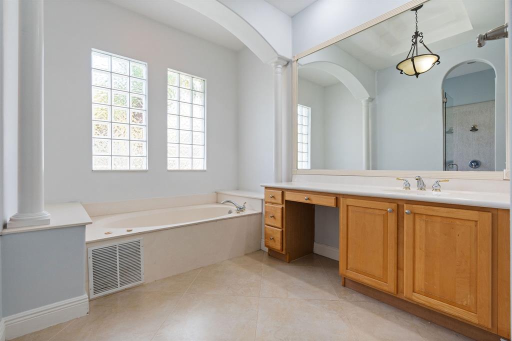15651 Southwest 15th Street Davie, FL 33326 - Photo 32 of 47 a spacious bathroom with a double vanity sink a mirror and a bathtub