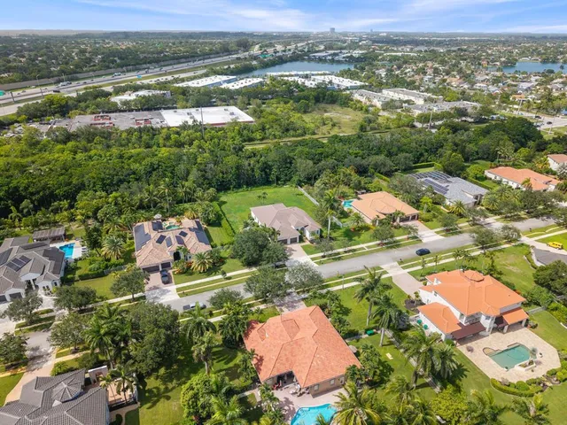 an aerial view of residential houses with outdoor space and river
