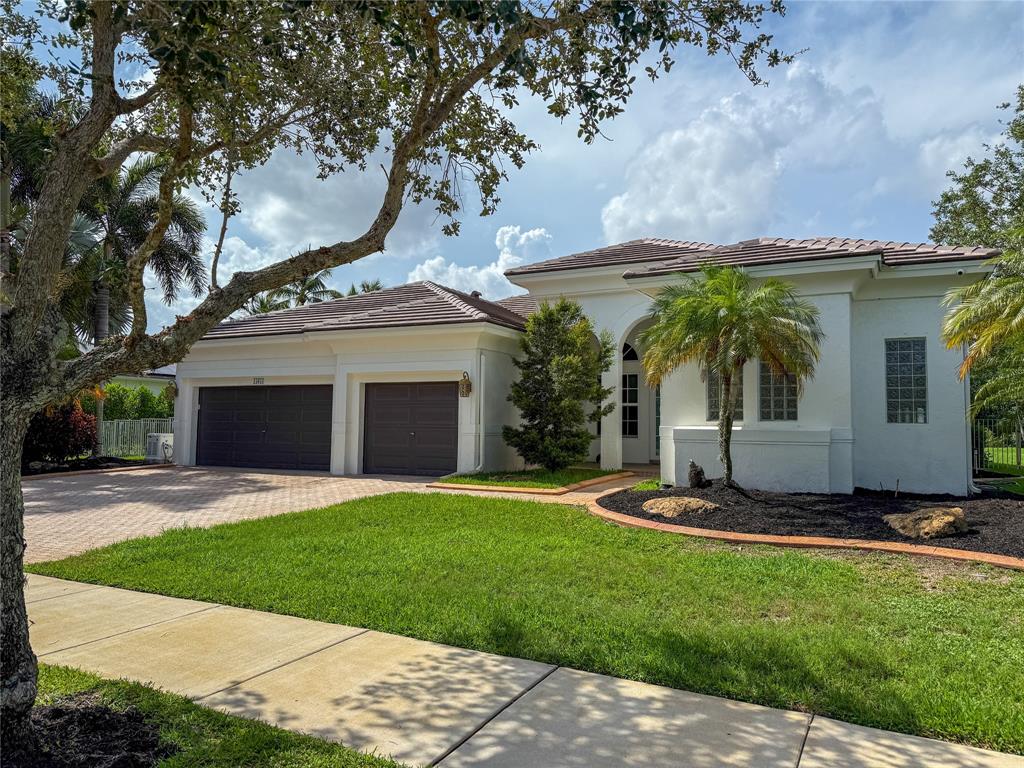 15651 Southwest 15th Street Davie, FL 33326 - Photo 6 of 47 a front view of a house with a yard and garage