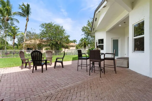a view of a patio with a table and chairs