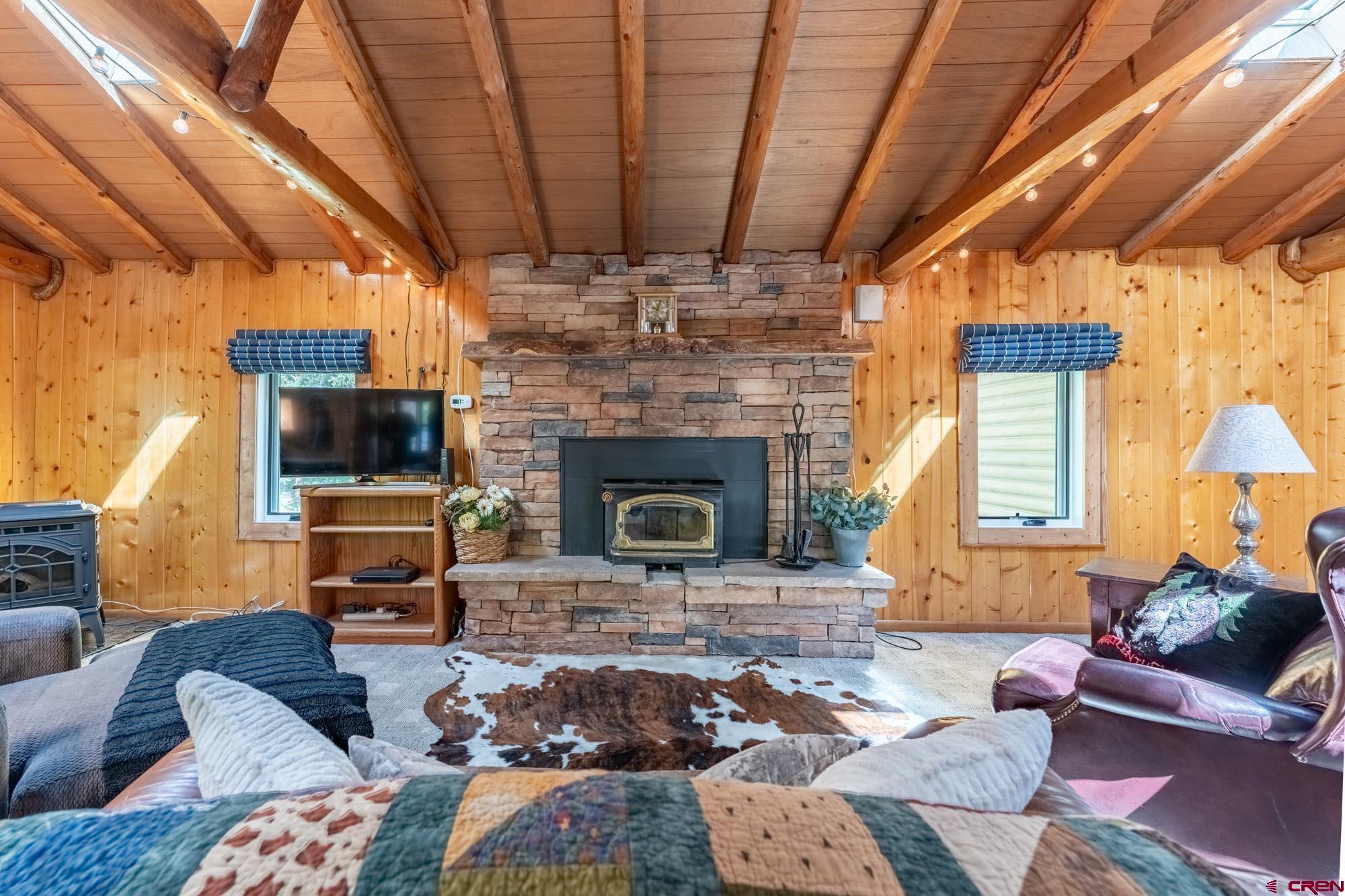 95 Deerpath Lane, Unit RIVERFRONT Almont, CO 81210 - Photo 13 of 35 a living room with furniture and a fireplace