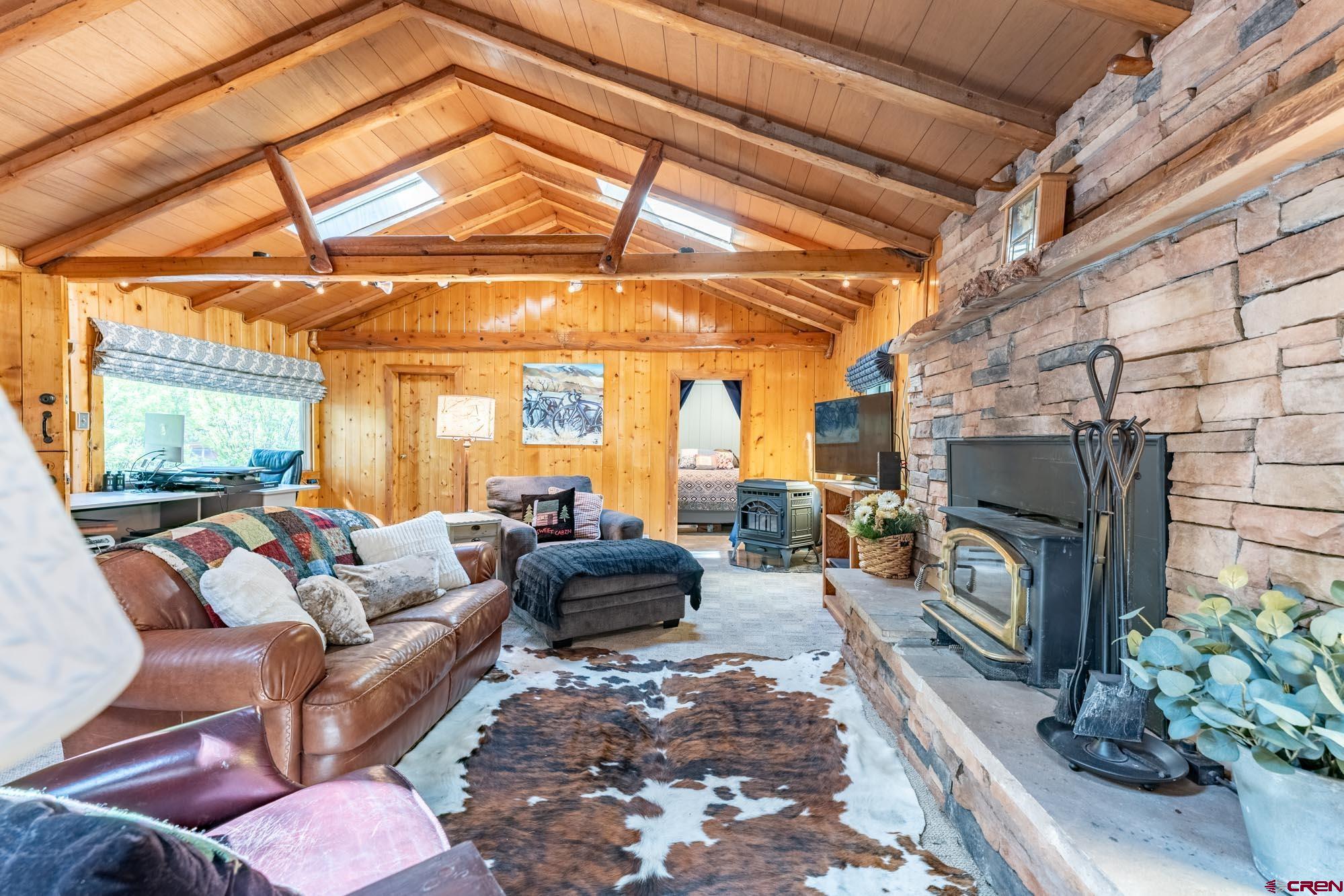 95 Deerpath Lane, Unit RIVERFRONT Almont, CO 81210 - Photo 14 of 35 a living room with furniture a fireplace and a table