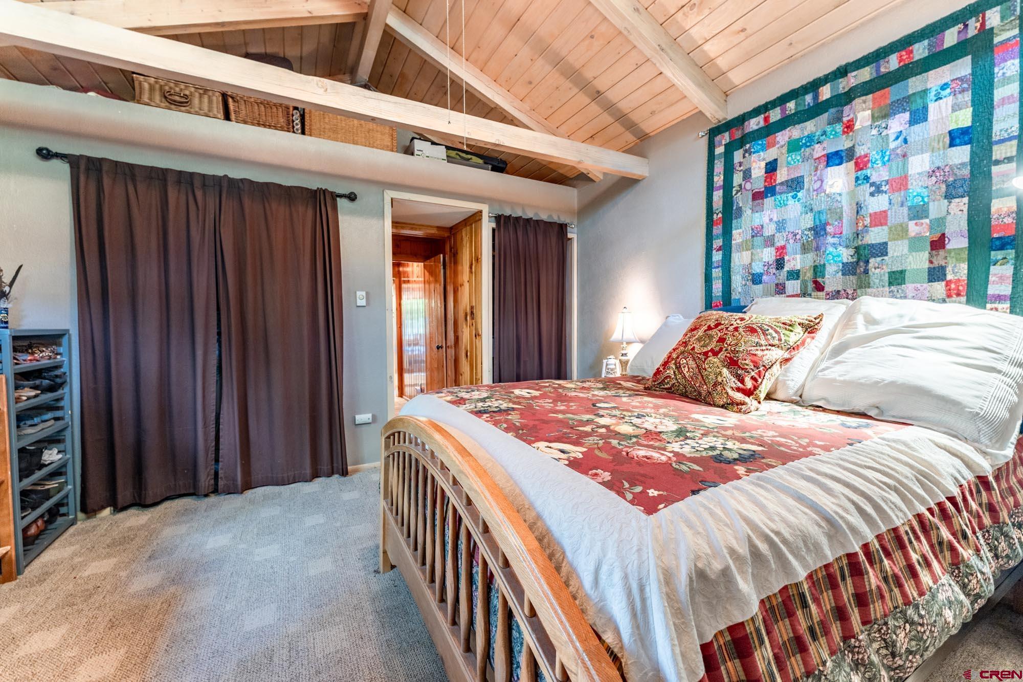 95 Deerpath Lane, Unit RIVERFRONT Almont, CO 81210 - Photo 24 of 35 a bed sitting in a bedroom next to a book shelf