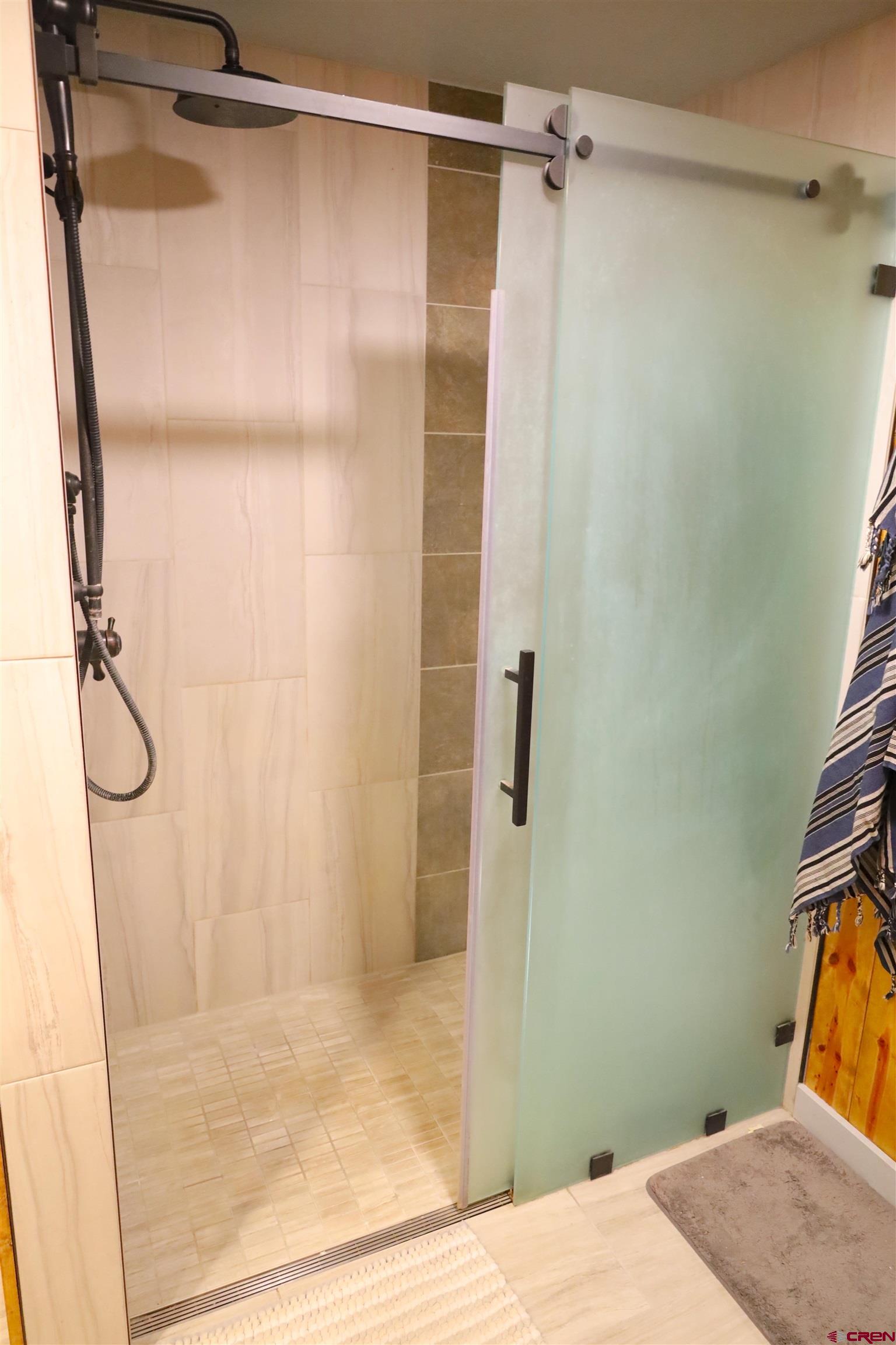 95 Deerpath Lane, Unit RIVERFRONT Almont, CO 81210 - Photo 25 of 35 a bathroom with a shower and a glass door