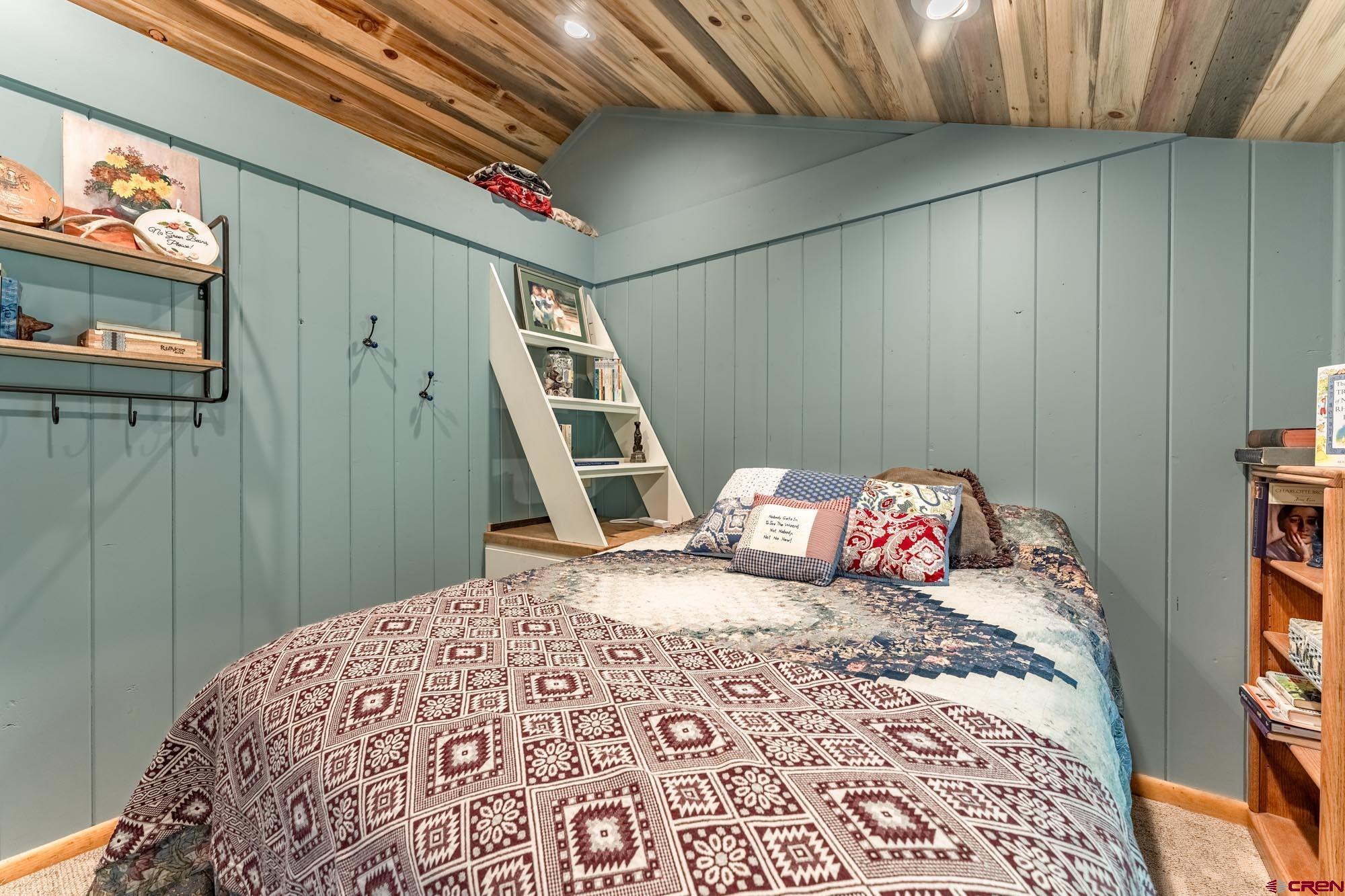 95 Deerpath Lane, Unit RIVERFRONT Almont, CO 81210 - Photo 27 of 35 a bedroom with a bed and a flat screen tv