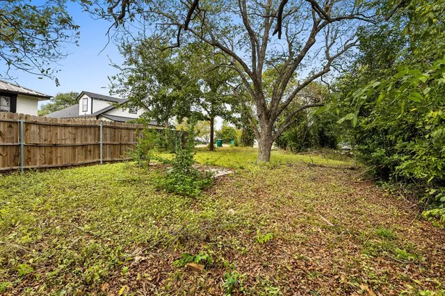 a view of a backyard with large trees