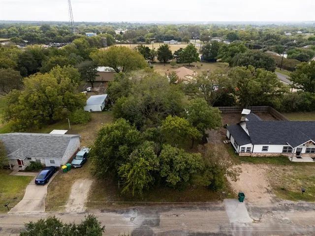 an aerial view of residential houses with outdoor space and river