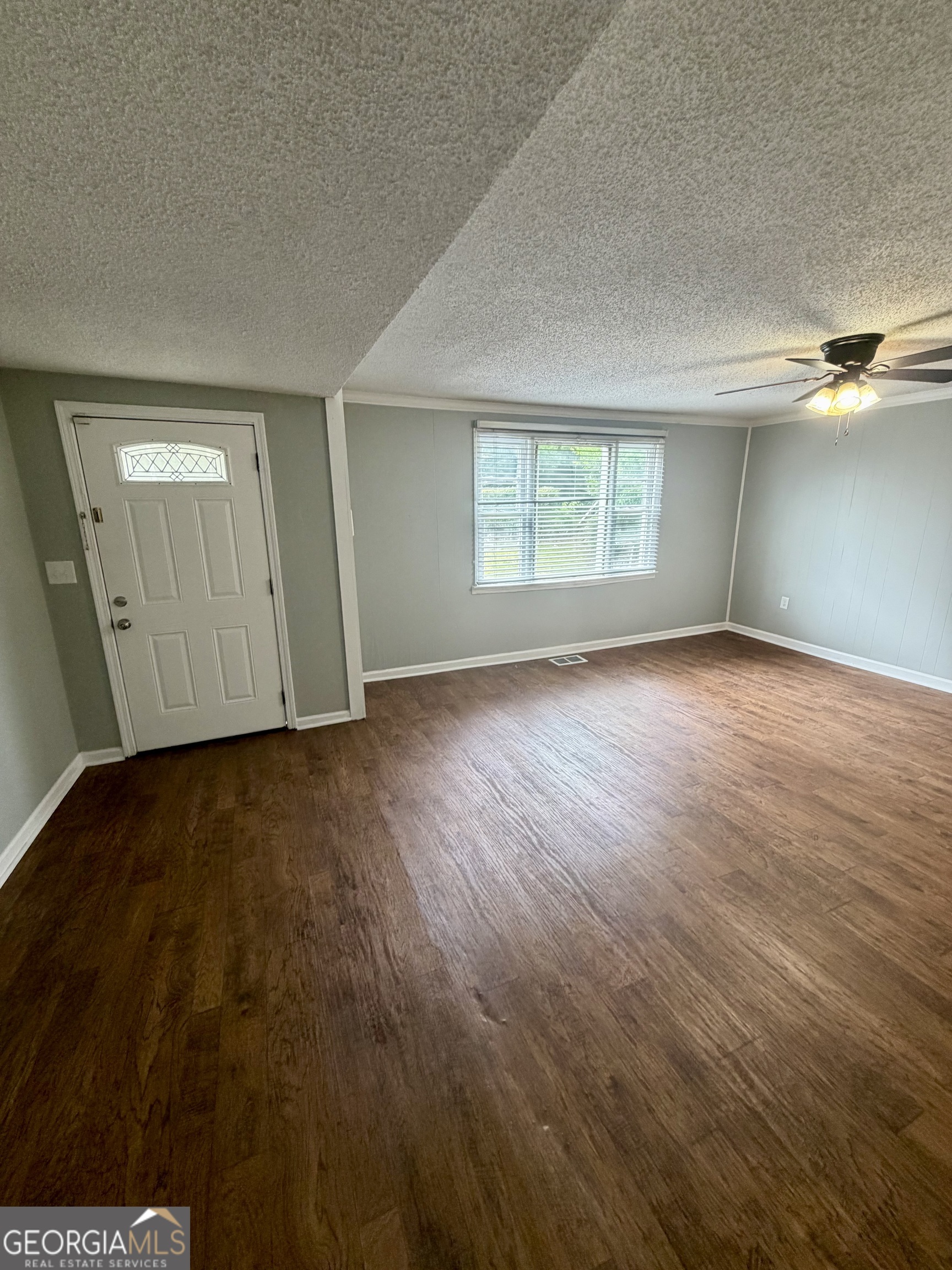 666 Woolfolk Street Macon, GA 31217 - Photo 7 of 60 an empty room with wooden floor and windows