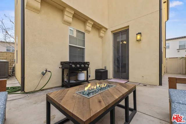 a living room with furniture a flat screen tv and a table