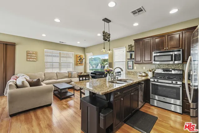 a large kitchen with stainless steel appliances granite countertop a lot of counter space