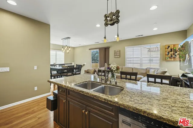 a kitchen with stainless steel appliances granite countertop a sink a counter space and cabinets