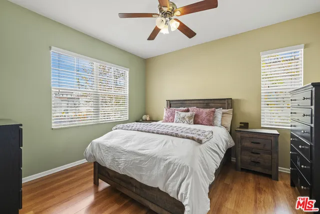 a bedroom with a bed a dresser and a window