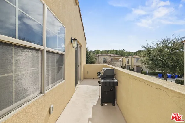 a view of a balcony with couches and sky view